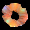 Detailed view of an orange glowing LED hair scrunchie with vibrant light effects - LED Glowing Style / Yellow