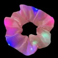 Close-up view of pink satin LED scrunchie with vibrant multi-color glowing lights - LED Glowing Style / Pink