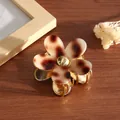 Close-up of small acetate flower hair claw clip with vintage leopard print petals - Light Coffee