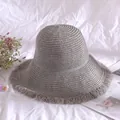 Grey women's straw bucket hat with wide brim and frayed edges for summer sun protection - M (56-58cm) / Light Gray
