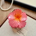 Detail view of a pink and orange gradient flower hair claw clip with delicate petals - Camellia / 8cm / Watermelon red