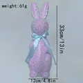 Handcrafted glittery purple Easter bunny figurine with a decorative blue ribbon bow - 33cm Height / Purple