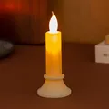 Detailed close-up view of the warm glowing flame on a simulated LED electronic candle light - Beige Medium