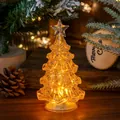 Atmospheric glowing LED mini Christmas tree on a wooden table with festive background decor - Large Gold Glitter Yellow Light