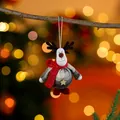 Close-up of handmade fabric reindeer Christmas ornament hanging on a natural branch. - Gray Deer