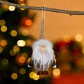 Charming fabric Christmas gnome ornament hanging on a branch with festive bokeh background - Coffee Santa
