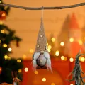 Detailed view of a handmade brown sequined Christmas gnome hanging ornament. - Braid Style Yellow Hat