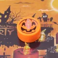 Detailed view of an orange Jack-o'-lantern LED tea light for spooky Halloween party decor - Pumpkin Pattern / Orange