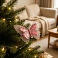 Exquisite close-up of a pink glitter butterfly ornament attached to a lit Christmas tree - Netted Butterfly / Set of 3 / Pink