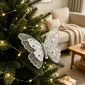 Close-up of a silver glitter butterfly ornament on a decorated Christmas tree branch. - Netted Butterfly / Set of 3 / Silver