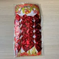 Pack of 12 shiny metallic red Christmas mini bows in festive holiday card packaging - Set of 12 / True Red
