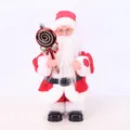 Detail of an electric standing Santa Claus doll holding a red lollipop ornament - Lollipop