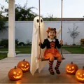 Cute Halloween glowing white ghost ornament hanging on a wooden swing in a garden scene - Solid Wood Ghost Swing (With Light)