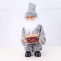 Close-up of electric standing Santa Claus figurine in gray suit for Christmas decoration - New Gray Santa Claus Holding Gift Box