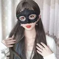 Elegant black lace masquerade half-face mask with glitter detail worn by a model for parties - Black