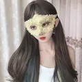 Detailed view of an elegant gold lace masquerade mask with sparkling rhinestone trim - Yellow