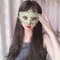 Close-up of elegant green lace masquerade mask worn by a woman for party costumes. - Green