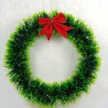 Festive green Christmas tinsel wreath featuring a classic vibrant red ribbon bow decoration - Flower Garland / 20cm / Green Border