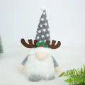 Detailed view of a Christmas gnome plush with grey knit hat and reindeer antlers - Gray