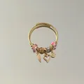 Detailed view of gold beaded wire bracelet with heart and angel wing charms. - Angel Wings Heart Pendant Style / Pink