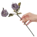 Hand holding a purple 2-head artificial rose with vintage autumn colors for home decor. - Purple