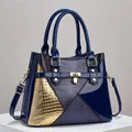 Detailed view of the patchwork glossy leather handbag with lizard pattern and gold hardware - Blue