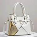 Close-up detail of a white and gold patchwork handbag featuring lizard texture - Off White