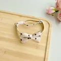 Detailed view of an adjustable beige floral pet collar with a bow tie on a wooden tray - One Size 23-40cm / Beige