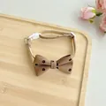 Close-up detail of brown floral pet bow tie collar with white buckle on wooden tray - One Size 23-40cm / Brown