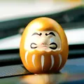 Traditional golden Japanese Daruma doll figurine for car dashboard and desk decor - Gold