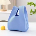 Chic light blue knitted wrist bag featuring a minimalist and stylish woven texture - 20x38cm / Solid Blue