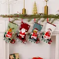 Four linen Christmas stockings with Santa, snowman and reindeer hanging on a mantel - Four-Piece Set