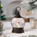 Vintage bronze Christmas snow globe lantern featuring a snowman and festive glitter detail - Snowman