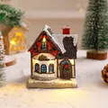 Detailed resin Christmas cottage ornament with warm LED lights on artificial snow. - Style D