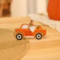 Close-up of Harvest gnome truck wooden ornament with festive Give Thanks engraving - Orange Truck