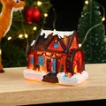 Glowing resin Christmas snow house with warm LED lighting and waterwheel detail - Style B
