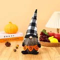 Detail of Halloween gnome faceless doll holding a BOO banner in a cozy festive scene - Plaid Hat Style