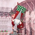 Close-up detail of a festive red Christmas stocking with a 3D grey plush gnome decoration - Long Leg with Beard