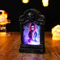 Close-up of glowing Halloween tombstone lamp featuring a grim reaper illustration - Tombstone Shape / Skull Pattern