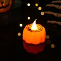 Close-up of Halloween LED pumpkin candle light with spider web design and warm glow - Spider Web Style