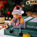 Plush Christmas bear ornament wearing a plaid hat and grey scarf sitting on books - Bear with Bead Chain