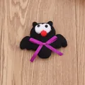 Detailed view of plush black Halloween bat brooch with a purple ribbon bow decoration - Glowing Bat