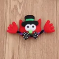 Close-up of red felt Halloween monster brooch with black hat and polka-dot bowtie - Glowing Red Cat