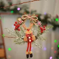 Close-up of a festive Christmas wreath with a plush reindeer and snowy pine branches - Small Dry Branch Wreath Reindeer