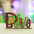 Detail view of festive wooden 'Believe' tabletop ornament with Christmas patterns - Horizontal Believe Style