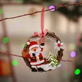 Close-up of a handmade rattan Christmas wreath with a felt Santa Claus pendant. - Santa Claus