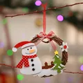 Close-up of a handmade Christmas rattan wreath with a cute felt snowman and tree. - Snowman Style