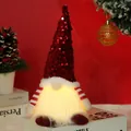 Detail showing warm LED lighting and sequined hat on a Christmas gnome ornament - Red