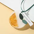 Elegant handmade scented wax tablet featuring a dried orange slice with green ribbon - Orange & Wind