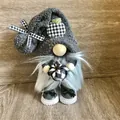 Detailed shot of a grey plush gnome holding a black and white checkered pumpkin prop - B&W Plaid Pumpkin (D2-23) / Black and White